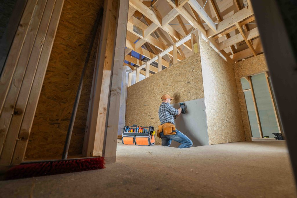 A photo of home builders constructing a new house.